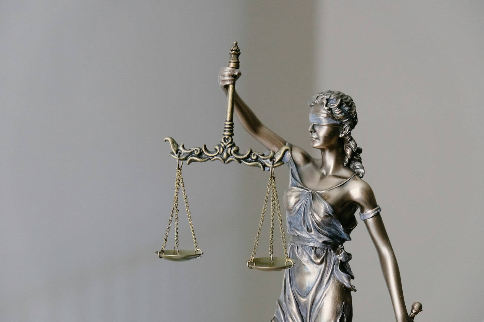 Bronze statue of a blindfolded Lady Justice holding a set of scales